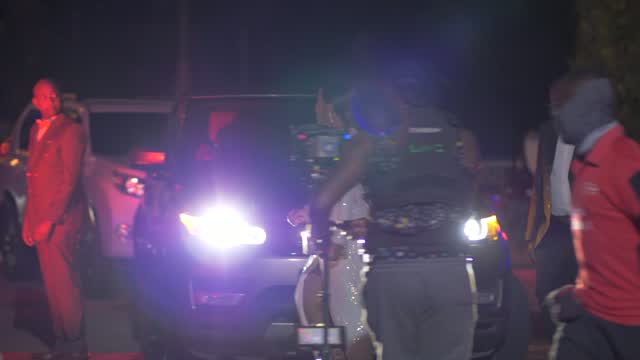 Night exterior car scene with crew