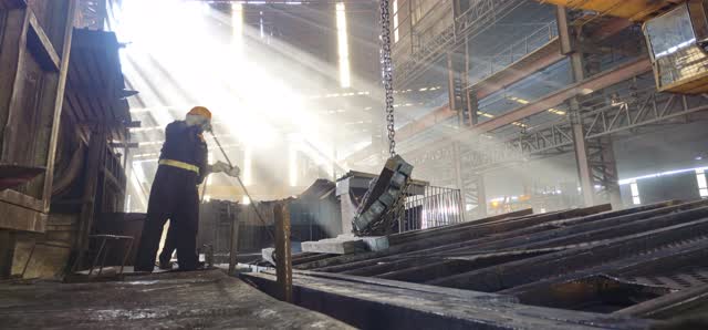 Worker under light shafts